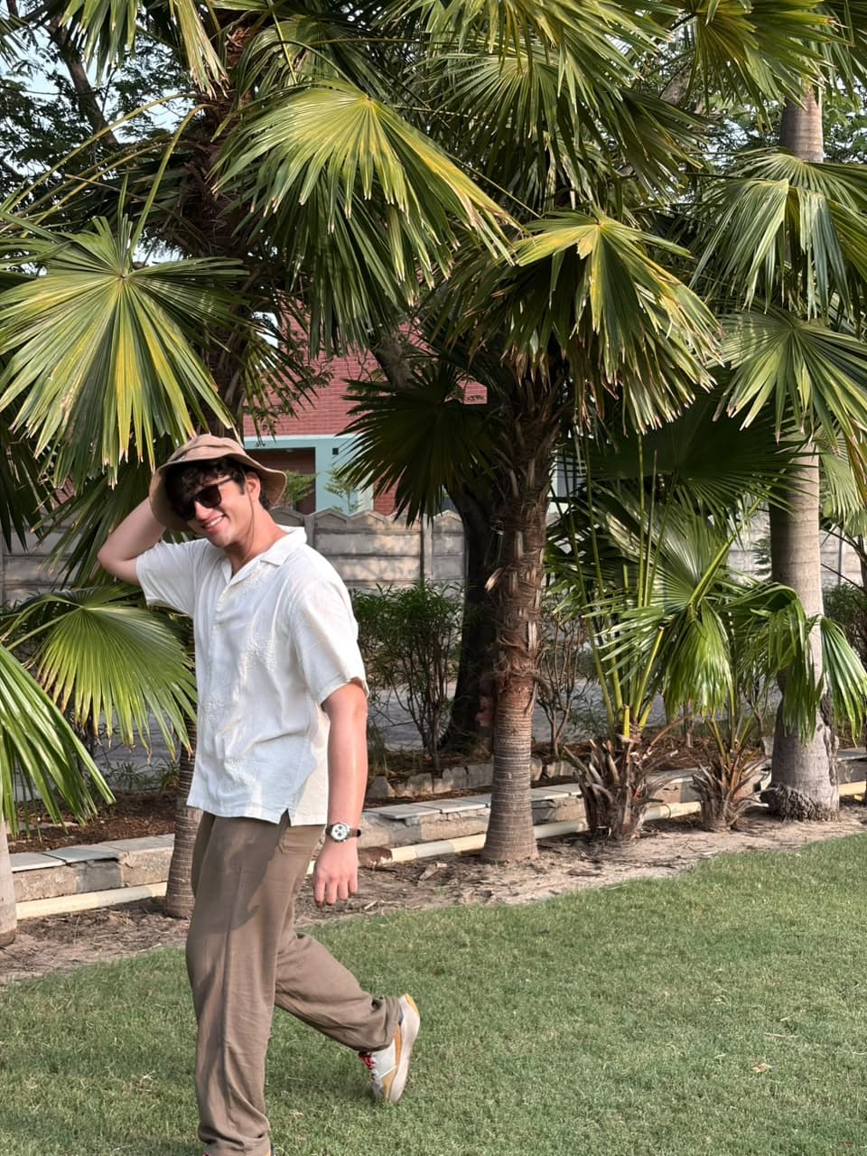 Samir Gajjar walking under palm trees, casual lifestyle